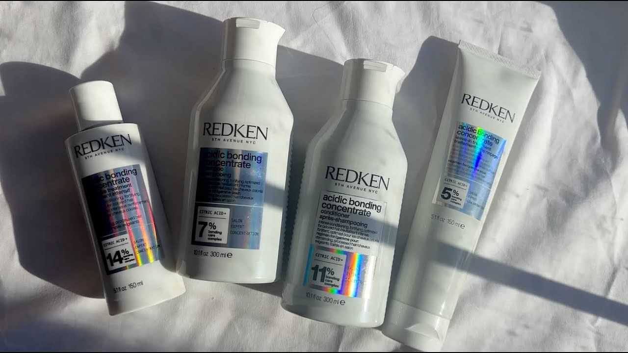 Redken Acidic Bonding Concentrate shampoo and conditioner bottles displayed on a white surface.